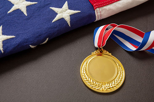 American flag with a gold medal