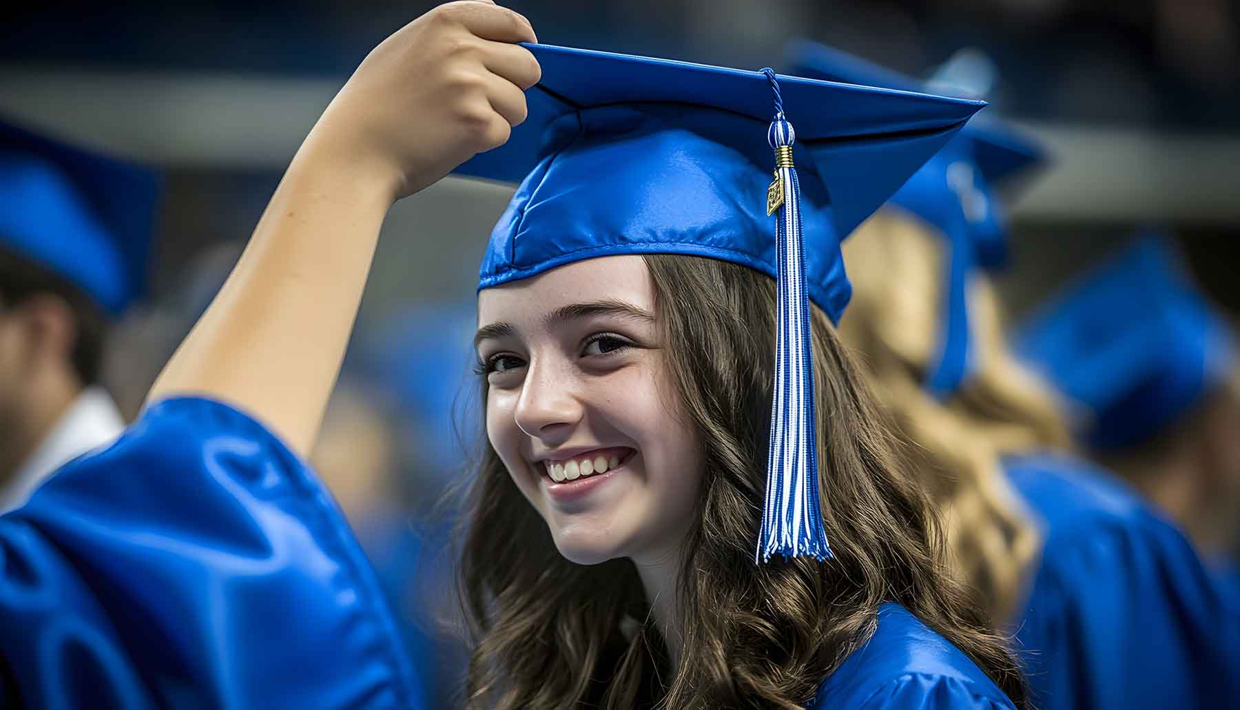 Graduate wearing a blue cap and gown