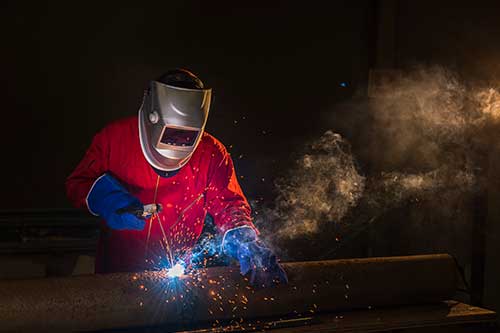 Welder wearing a welding mask