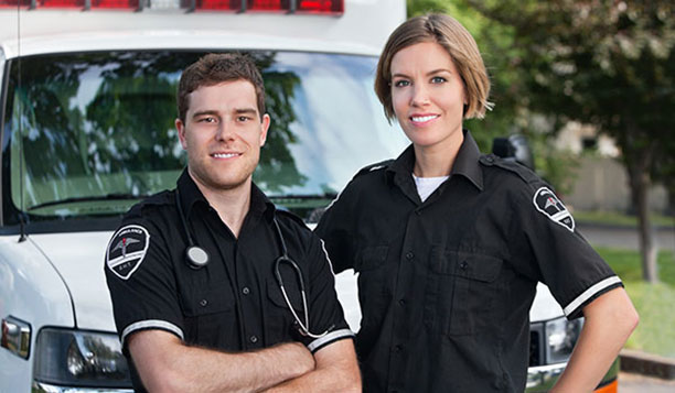 Paramedics standing in front of an ambulance