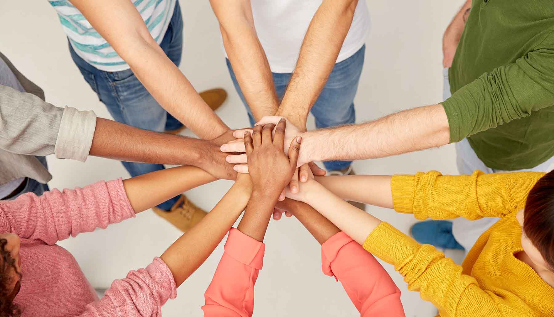 Group of people with their hands together